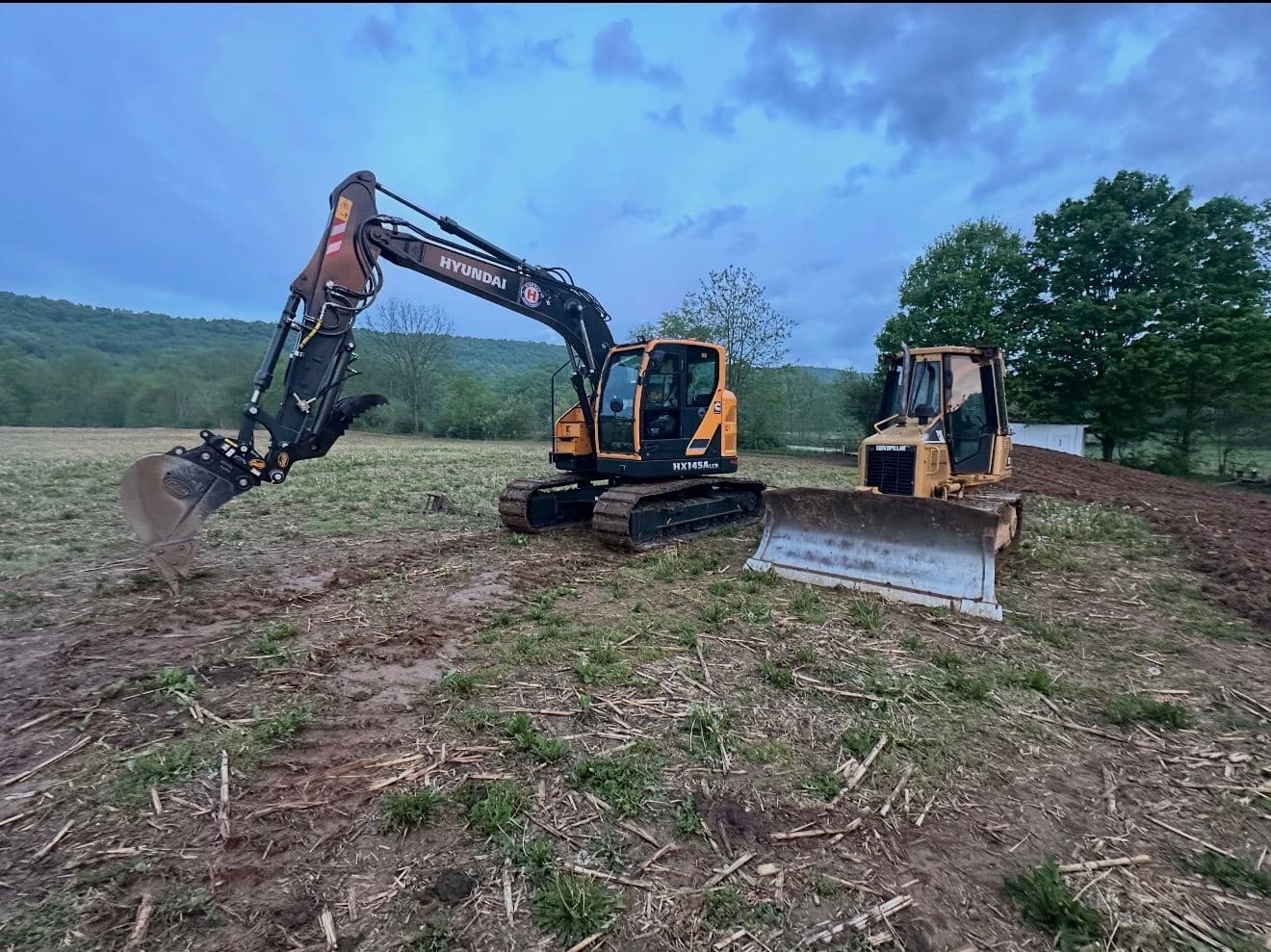 Hyundai HX145A LCR excavator and CAT dozer clearing a field in Bedford County PA