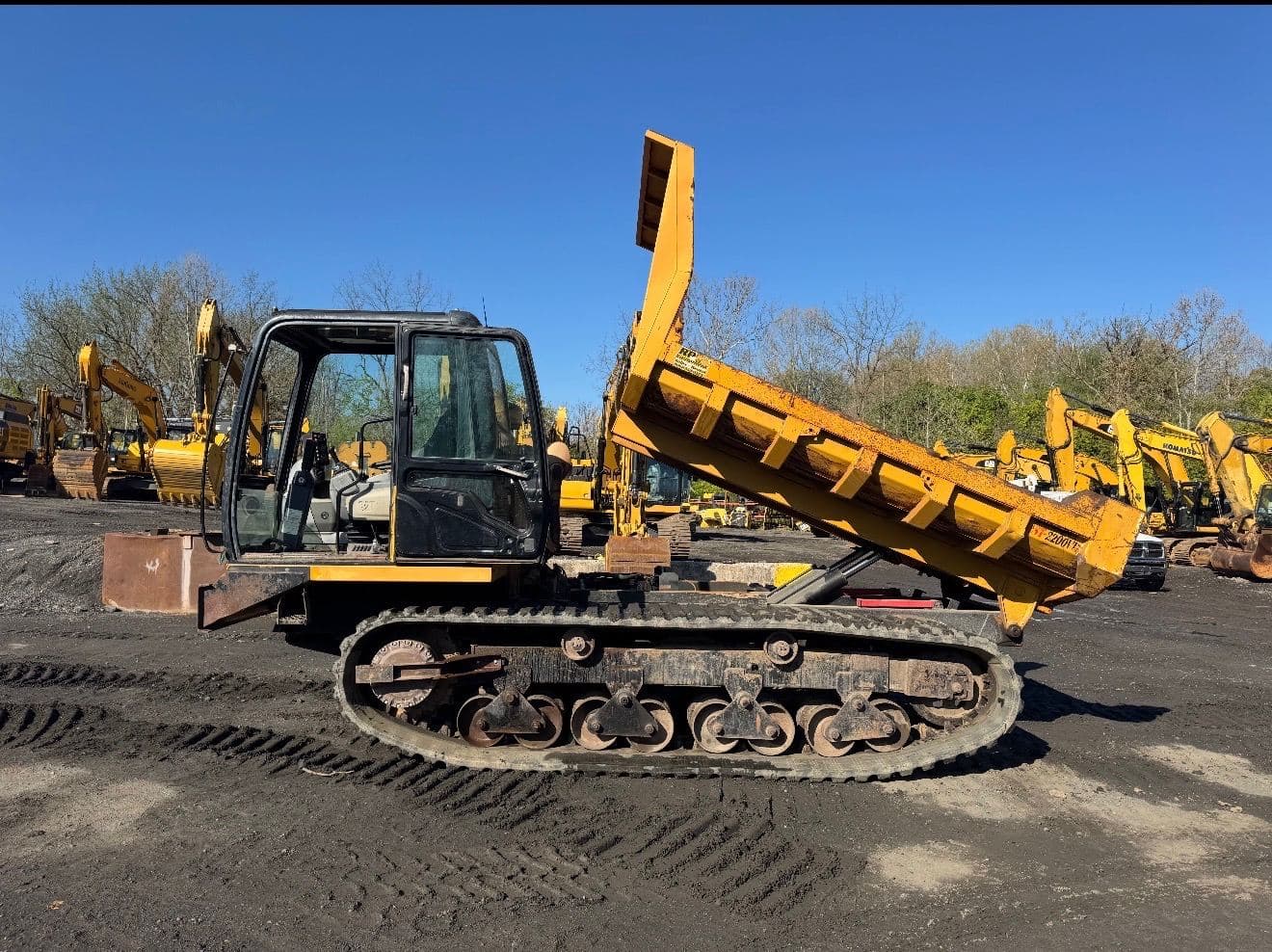 Tracked dump truck with bed raised